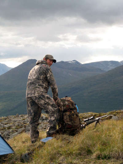 Scott stuffing his backpack for the hike